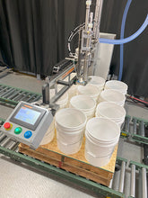 Load image into Gallery viewer, Drum tote pail filling machine filling 12 pails on a pallet on a roller conveyor