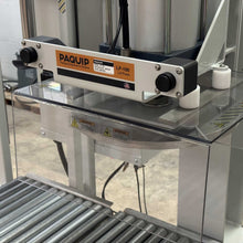 Load image into Gallery viewer, LP-100 lid press bucket sealing machine on a conveyor roller belt in an industrial setting