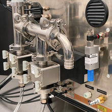 Load image into Gallery viewer, Rear side of the FG-200 bottle filling machine with a vacuum loading system and 1/2" hose barb fluid inlet above dual stainless pumps