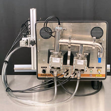 Load image into Gallery viewer, Rear of the FG-200 bottle filling machine with dual pumps and sanitary manifold on a stainless steel table