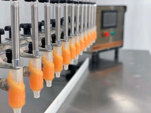 Load image into Gallery viewer, 12 Bottle filler nozzles on a rack with a FG-1200 benchtop filling machine